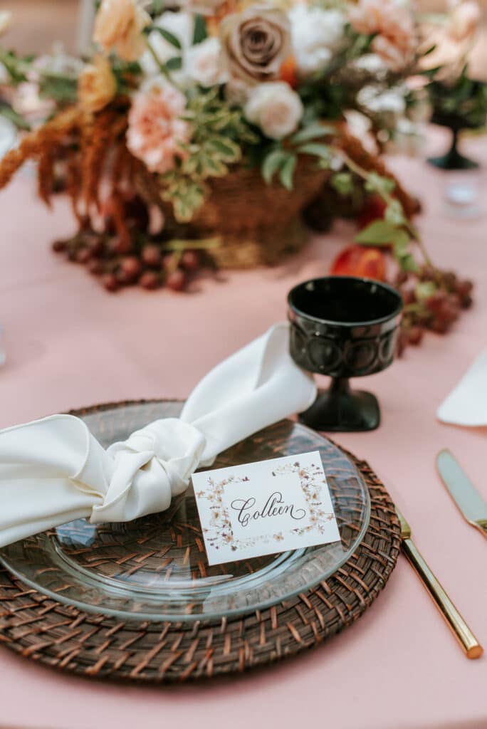 place setting at wedding reception with chargers, name plate and autumnal centerpieces by Sweet Pea Design Collective