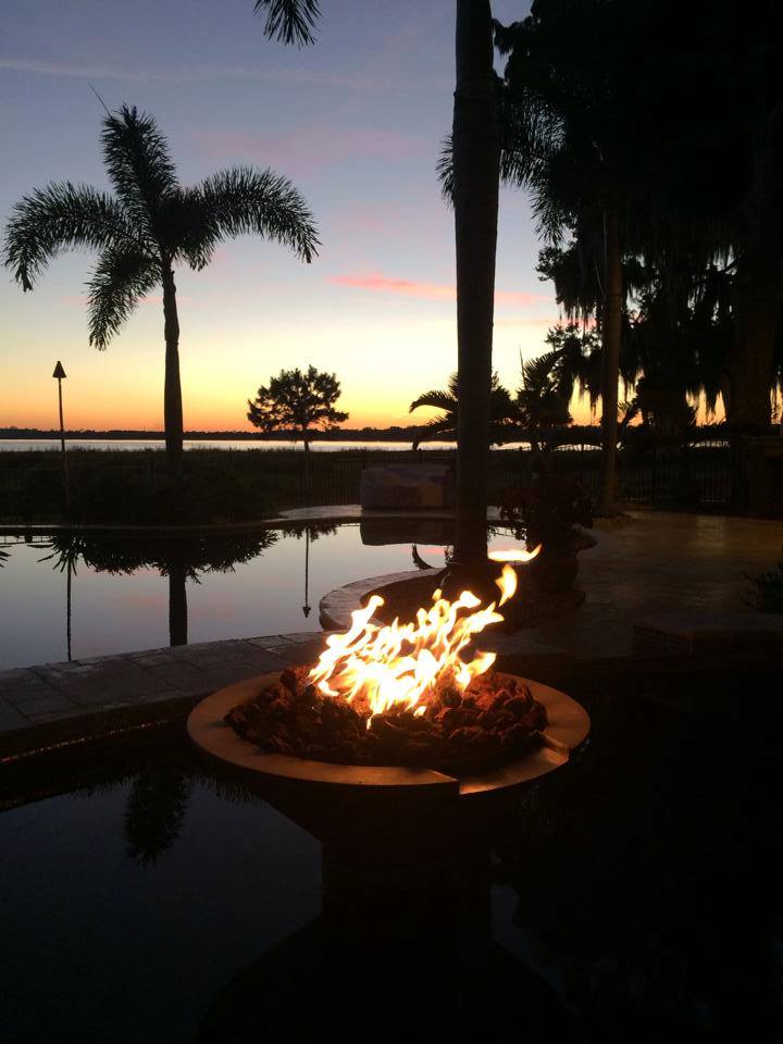 firepit from Orlando Special Effects against a sunset with a palm tree