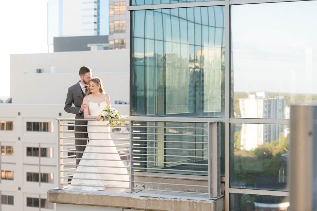 bride and groom looking out over city from The Balcony Orlando venue