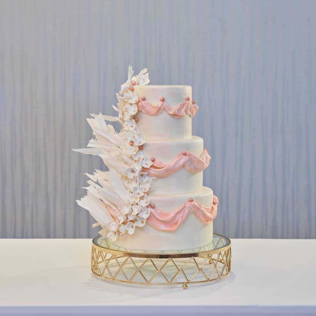 pink and white swan wedding cake at Walt Disney World Swan Reserve