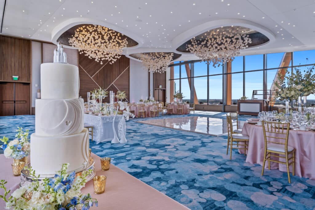 wedding reception with wedding cake and tables set at Walt Disney World Swan Reserve