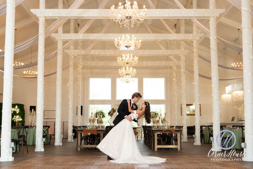 groom dipping his bride in ballroom of Ever After Farms Citrus Barn