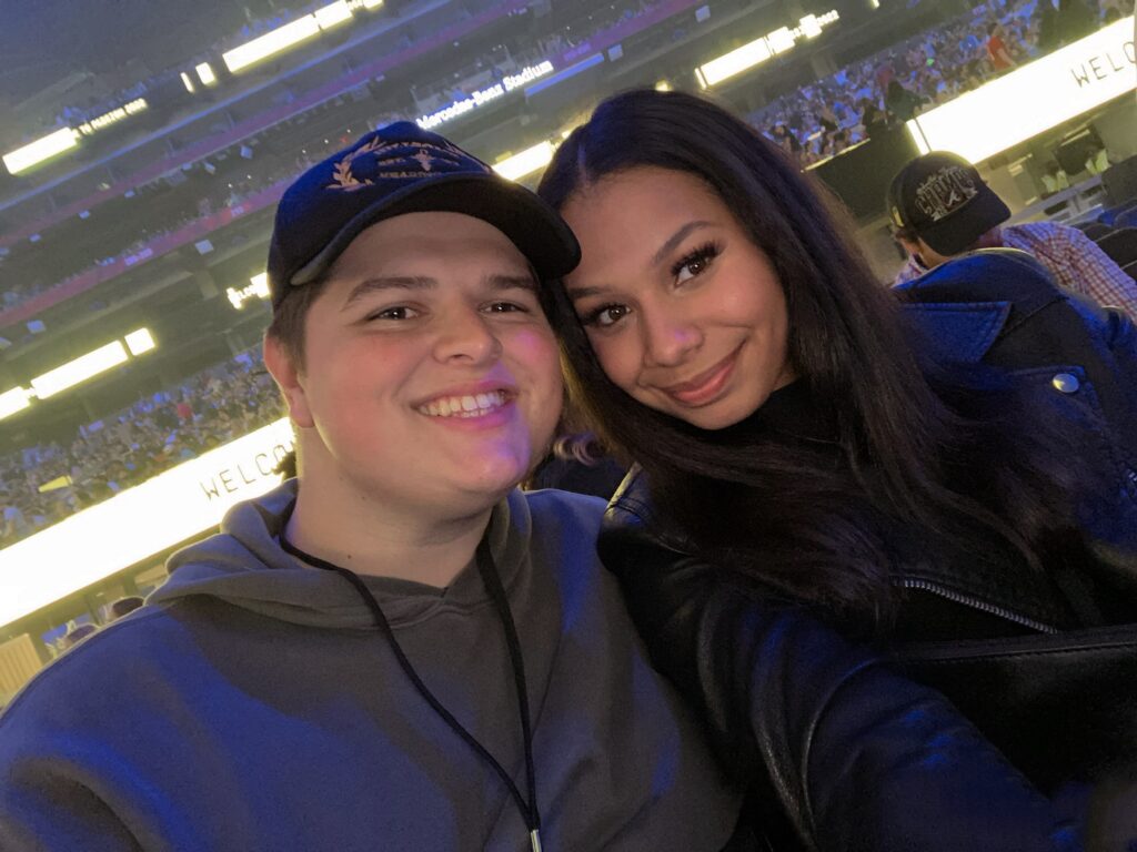 couple take picture at sporting event