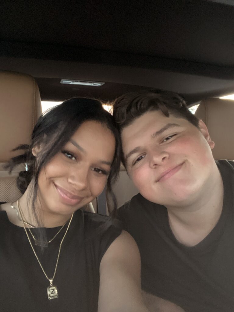 couple pose together with foreheads touching in car