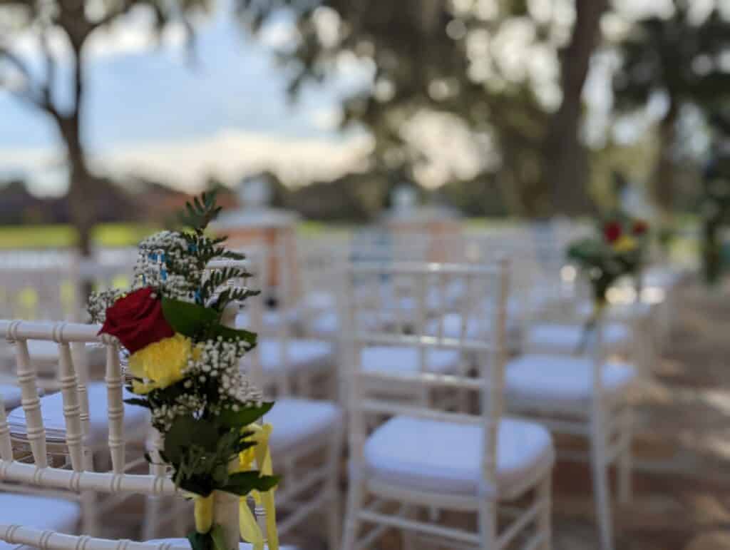 aisle flowers on the end of chairs at ceremony site coordinated by Events by Rachel