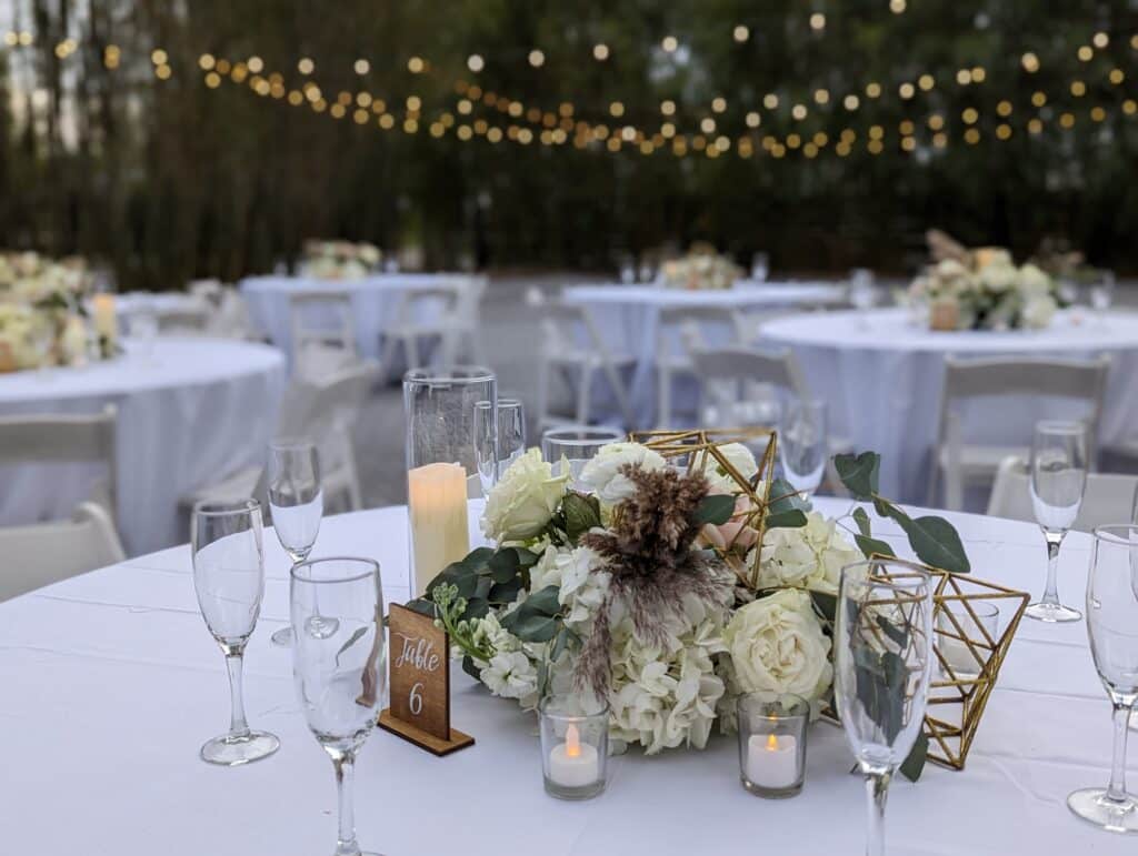 Centerpiece of hydrangeas in candles at wedding reception coordinated by Events by Rachel