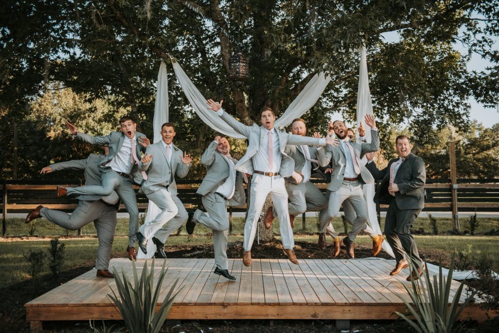 groom and groomsmen jumping for joy at Wanderlust Okto