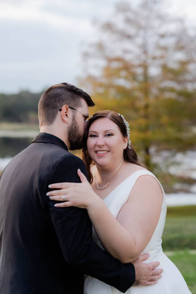 photo by Taylor Kuperberg Photography of bride smiling as groom whispers to her