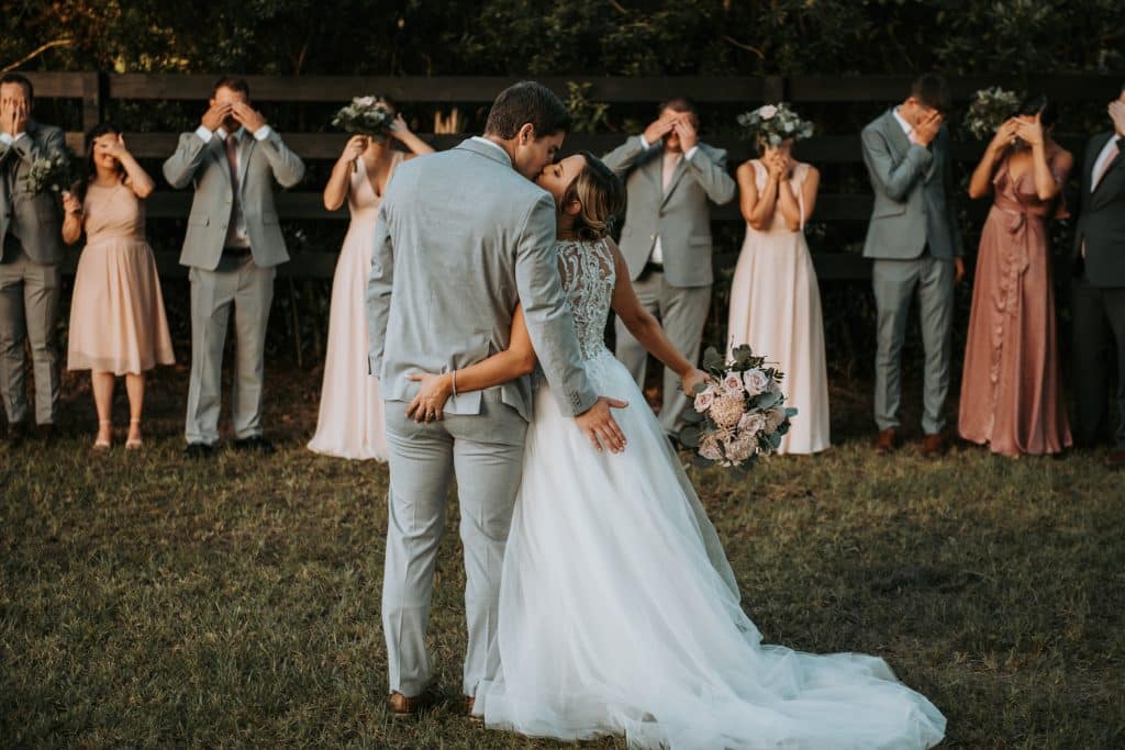 bride and groom giving butt cheek grabs as bridal party covers eyes at Wanderlust Okto
