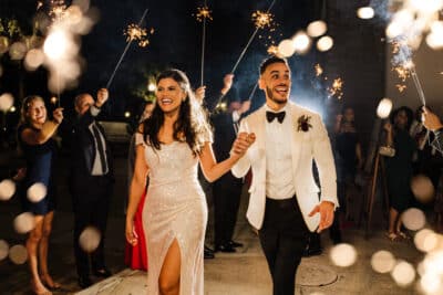 photo by Taylor Kuperberg Photography of bride and groom under arch of sparklers