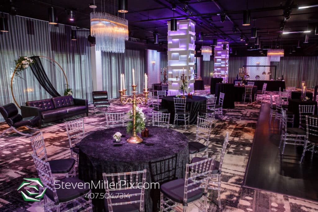 reception room with smokey gray and deep purple colors, lighted pillars and modern crystal chandeliers at The MEZZ