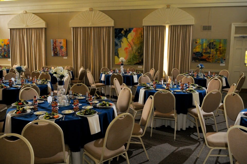 room set for a reception with black linens on round tables at The University Club of Winter Park