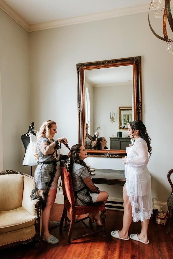 bride and bridesmaids getting ready in the bridal ready room at THE 1883 Historic Venue