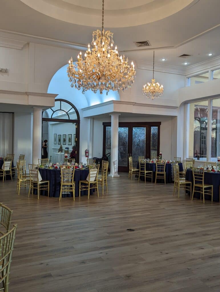 Wooden dance floor under Crystal chandeliers in wedding reception hall coordinated by Events by Rachel