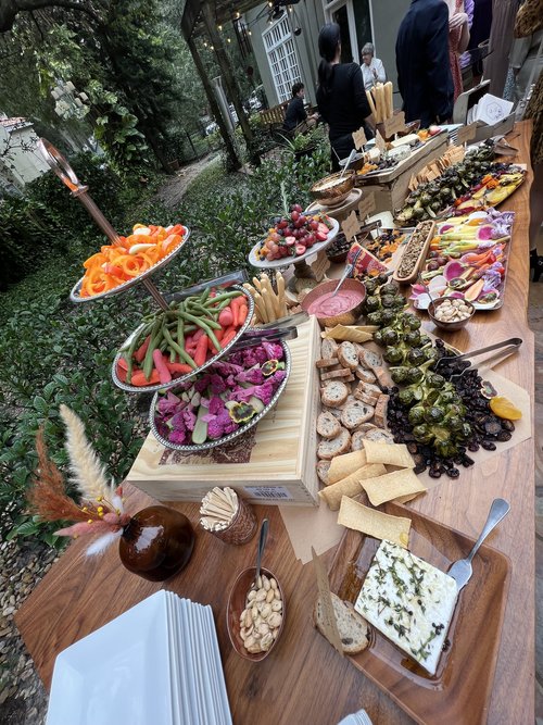 buffet table with assorted charcuterie by Uncommon Catering