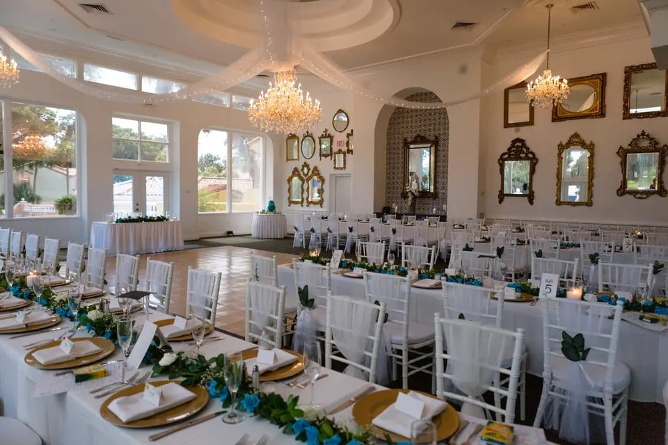 long tables set with low green centerpieces and gold charges at La Cita Country Club