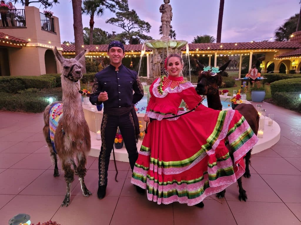 man and woman in traditional clothing with llamas from Entertainment City Productions