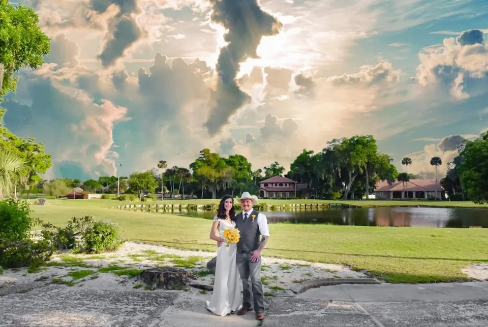 bride and groom standing by golf course under stunning sky at La Cita Country Club