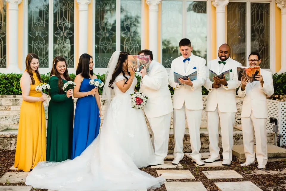 bride and groom kissing while groomsmen ready and bridesmaids giggle at La Cita Country Club