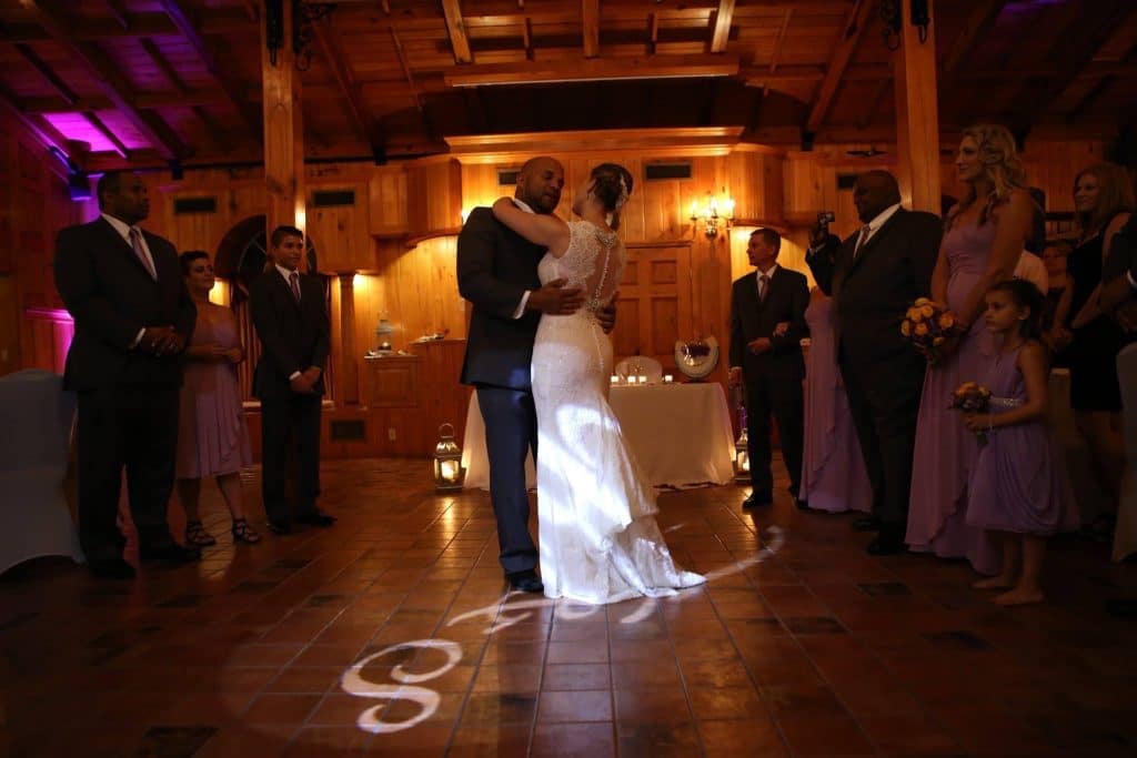 bride and groom dancing on dance floor lit with monograms planned by Soulovevent LLC