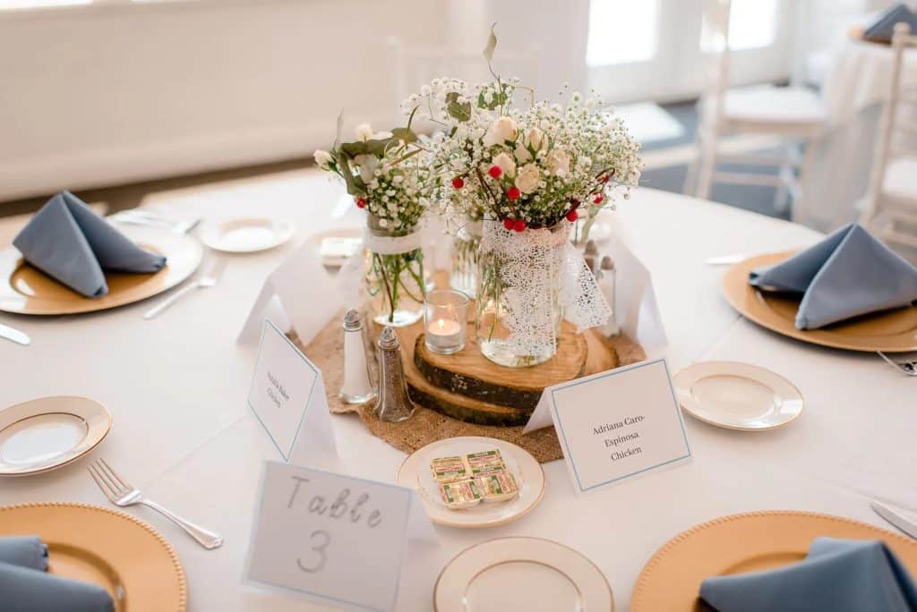 table setting with sweet babysbreath centerpieces, table numbers and assigned seating chart at La Cita Country Club