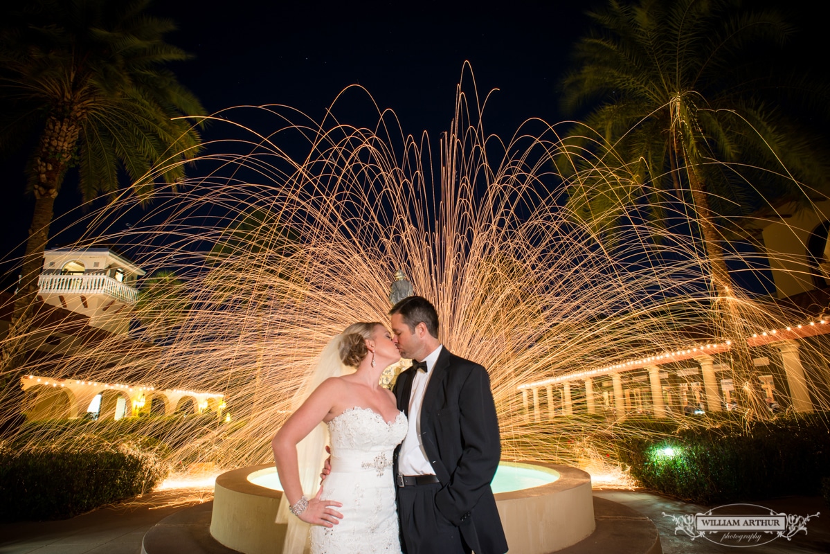 Mission Inn Resort wedding venue bride and groom in front of found with sparks behind them
