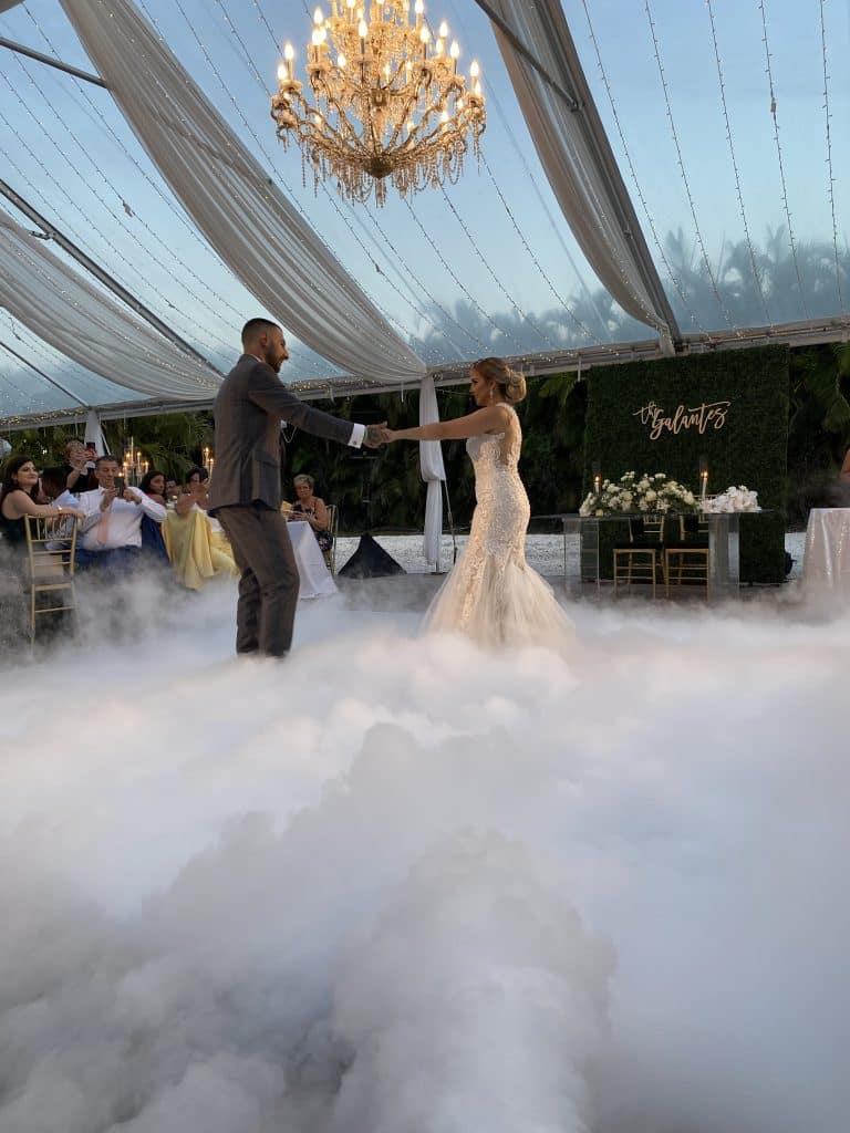 bride and groom dancing on a cloud, under a chandelier with music by DJ Renier