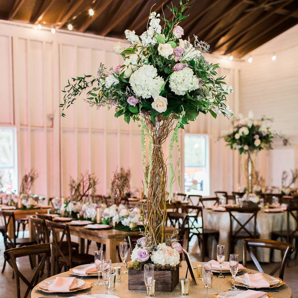 tall pink and white centerpieces with vine stems coordinated by Julie Miner Events