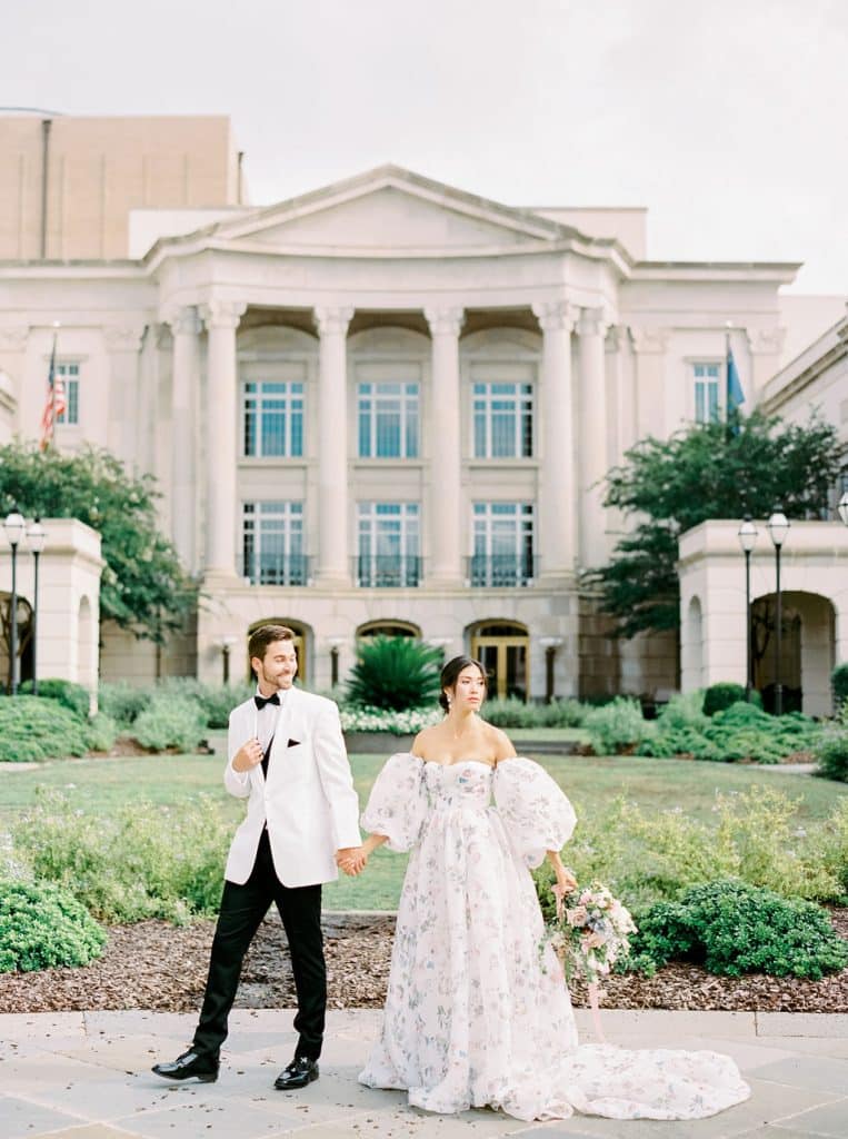 bride wearing gown and groom wearing white tuxedo dinner jacket from Carolyn Allen’s Bridals & Formals