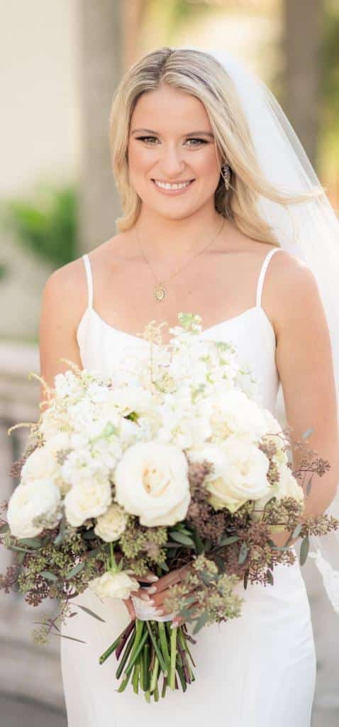 bride holding bouquet by Ian Tafoya Designs of blush roses and peonies