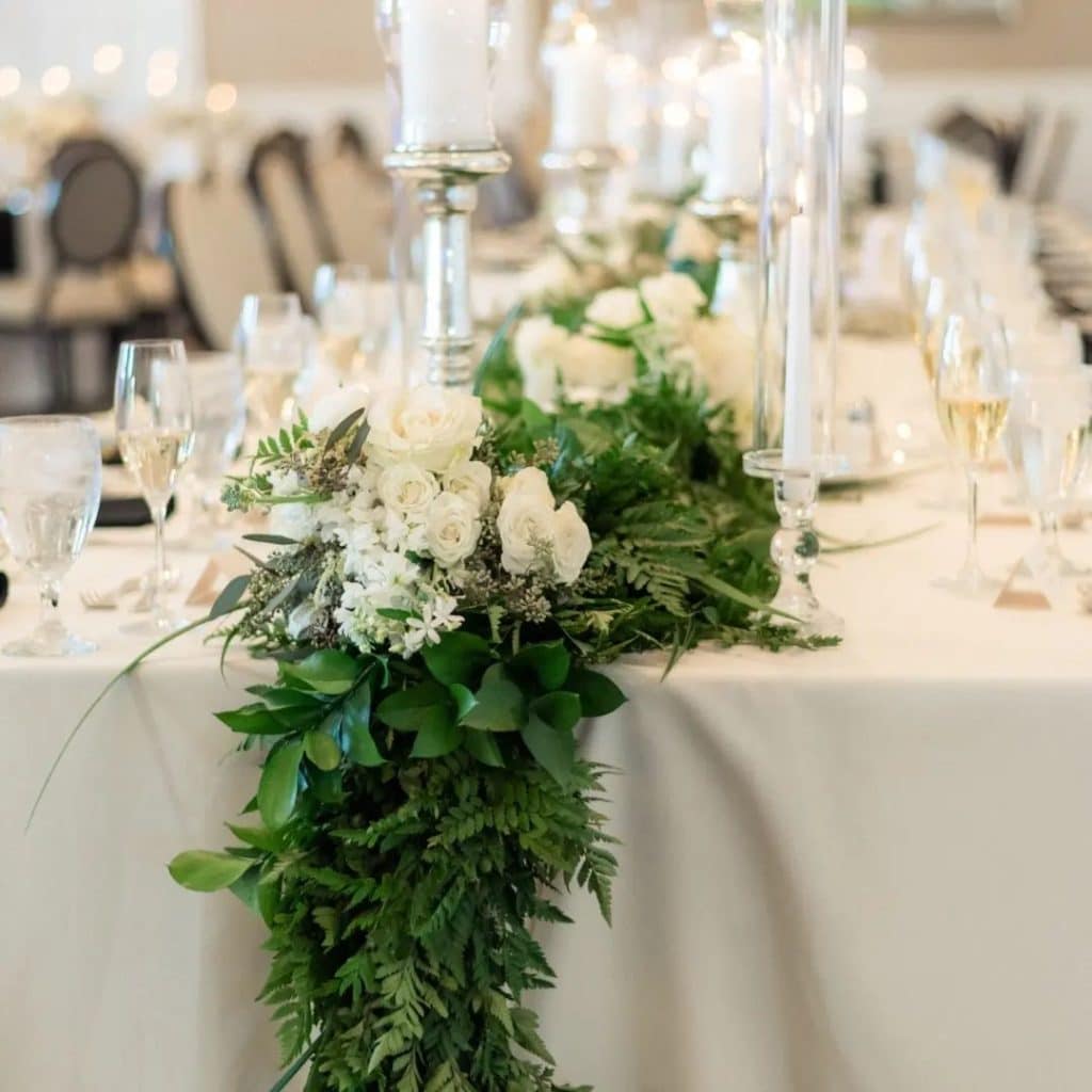 centerpiece of green fern and white roses by Ian Tafoya Designs