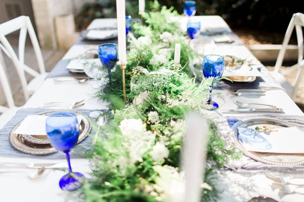 wedding table with blue and white accents and long green and white table centerpiece coordinated by Julie Miner Events