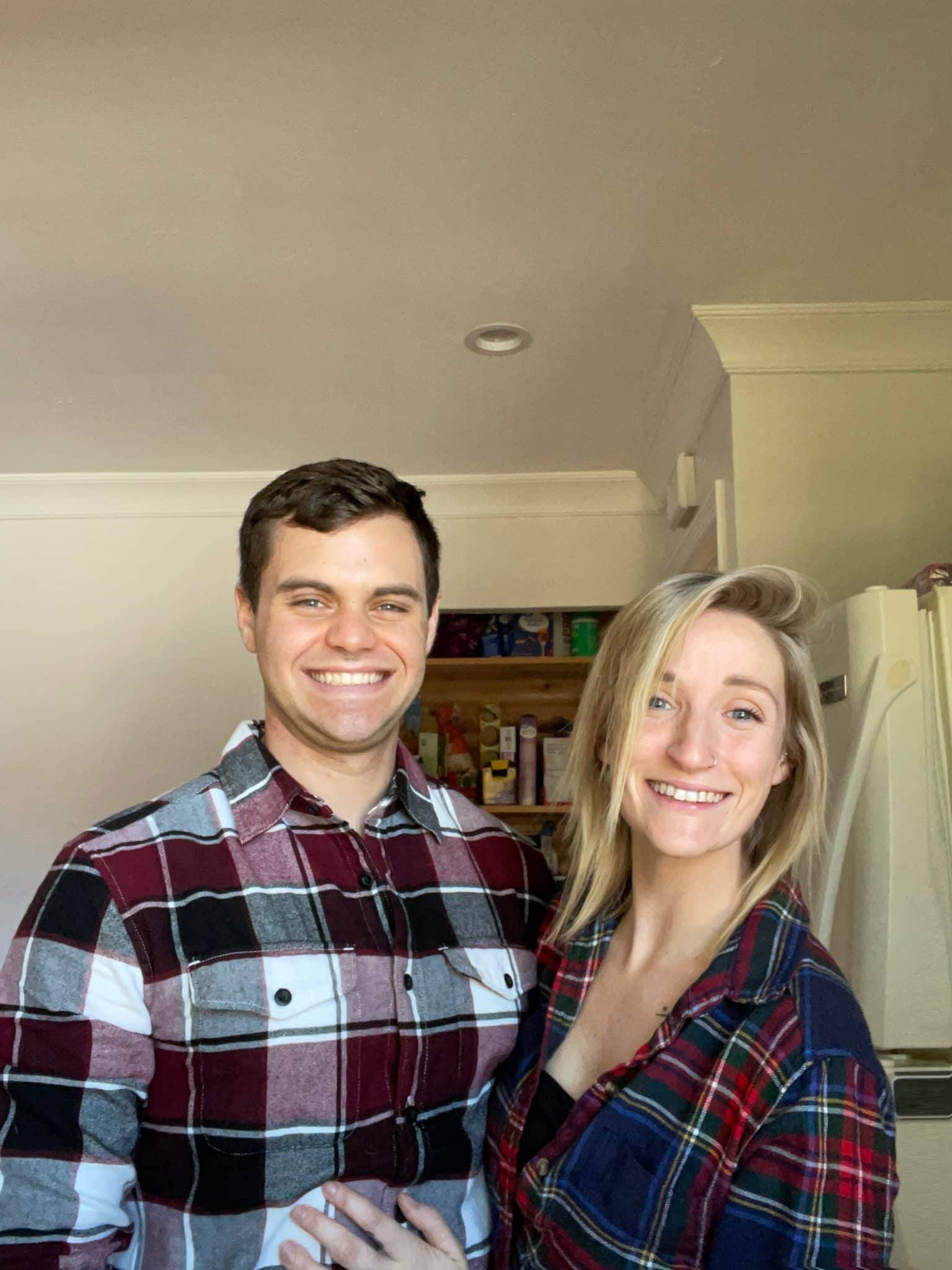 Couple wears matching red plaid shirts in photo together
