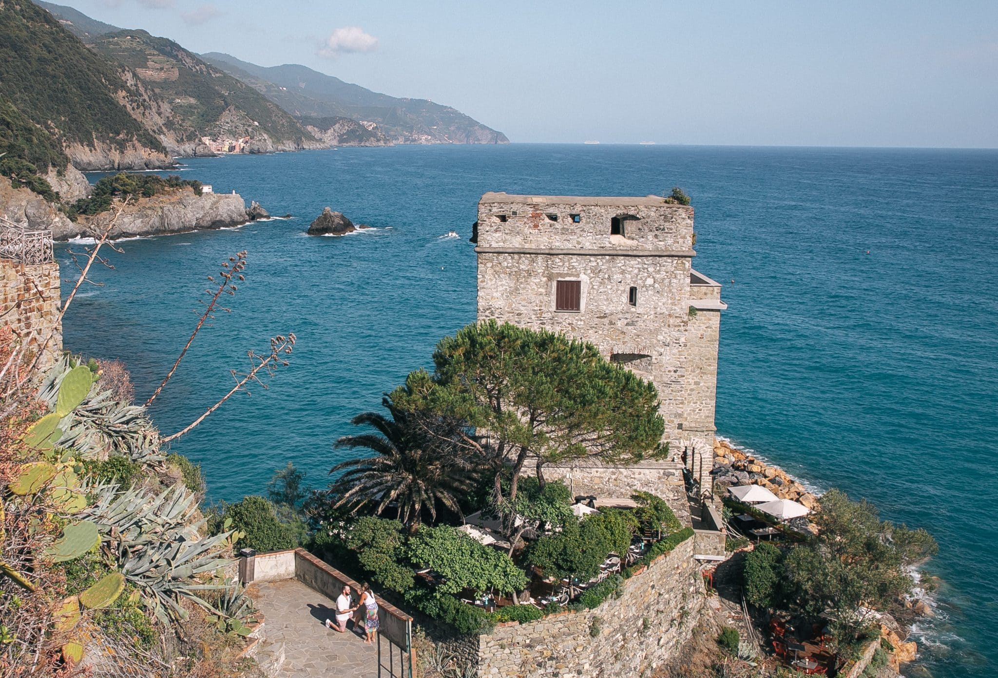 Surprise proposal in Italy overlooking castle and water view