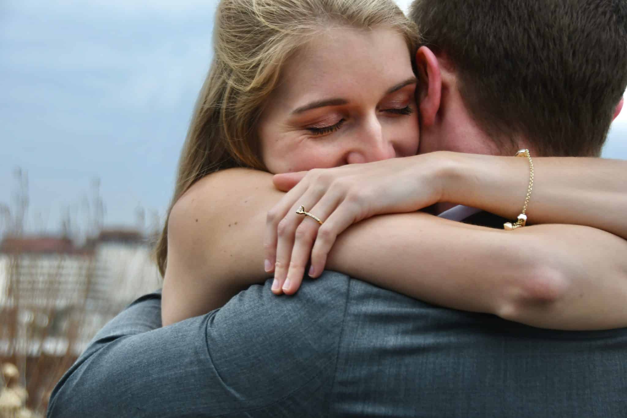 Couple embraced in a heartfelt hug.