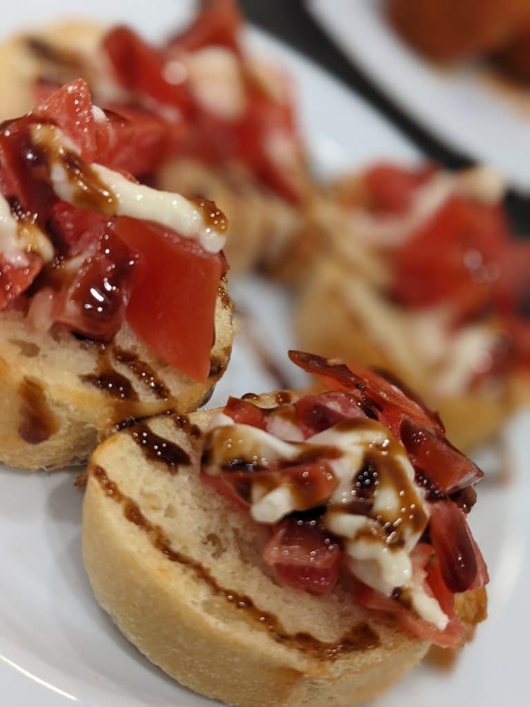 bruschetta toast with tomatoes, mozzarella and balsamic glaze from Latin Raices Catering