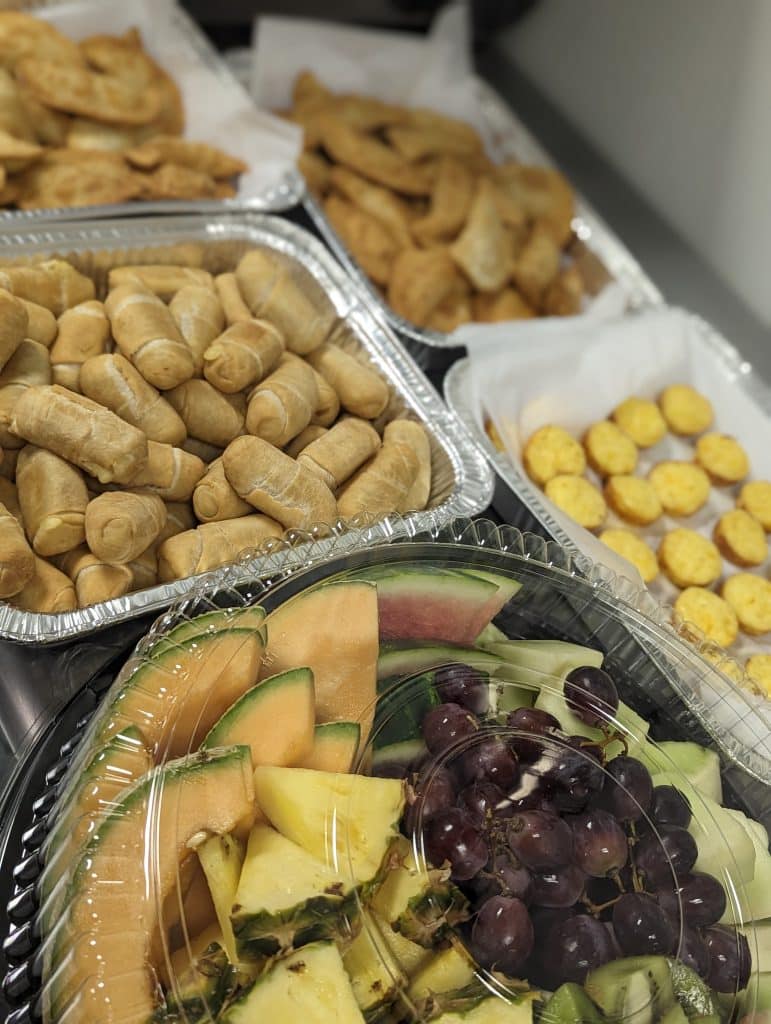 assorted appetizers, tostones, fresh fruit and mozzarella sticks from Latin Raices Catering
