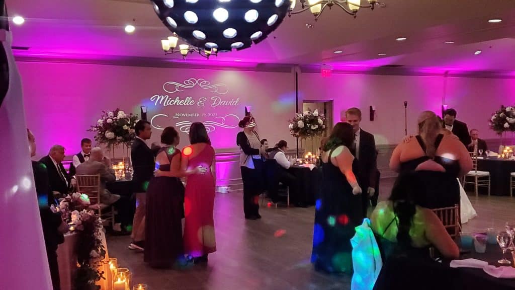 black and white disco ball with pink lit walls from Elegant Entertainment DJ and Video Services Orlando