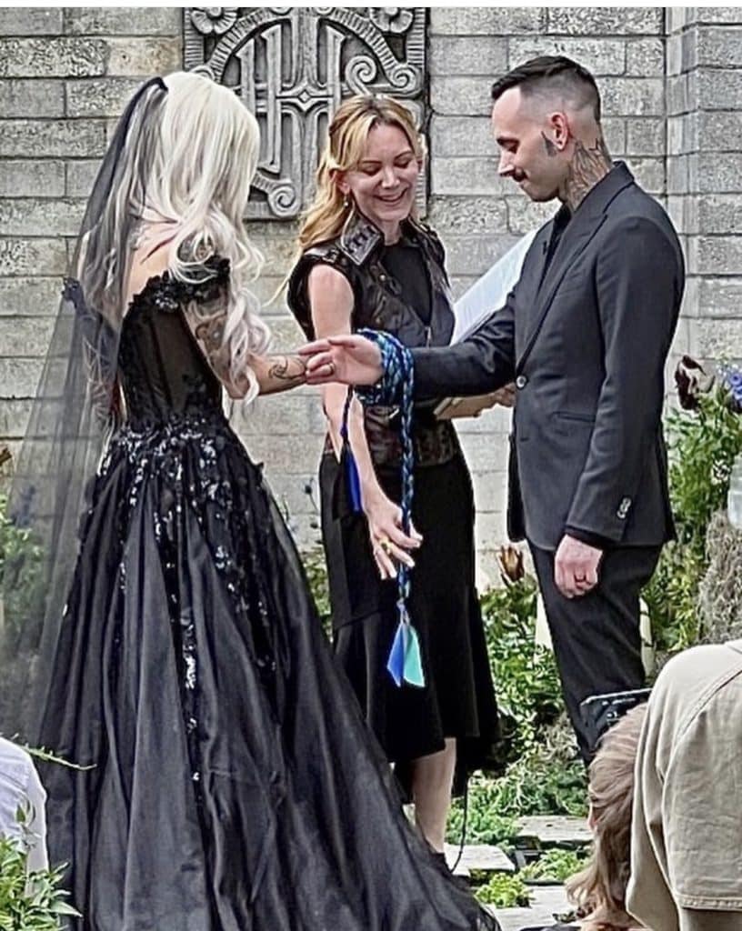 couple celebrating ceremony by binding wrists together by officiant from Freebird Ceremonies