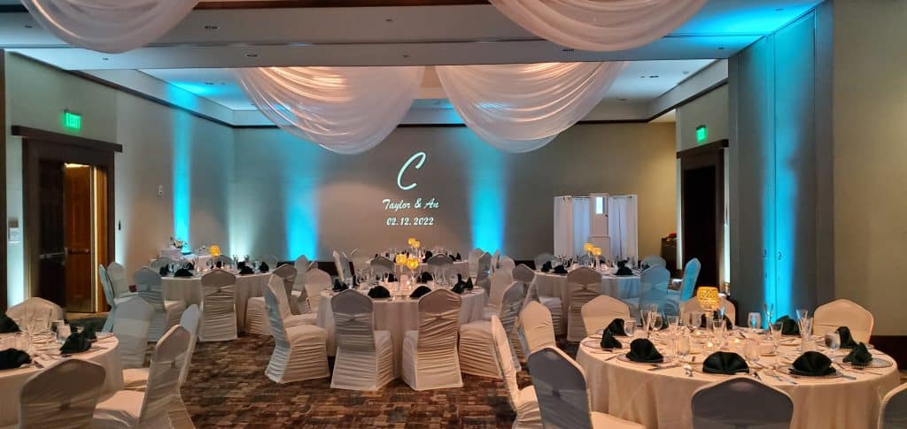 turquoise and white draped wedding reception room ready for the wedding to begin and music from Elegant Entertainment DJ and Video Services Orlando