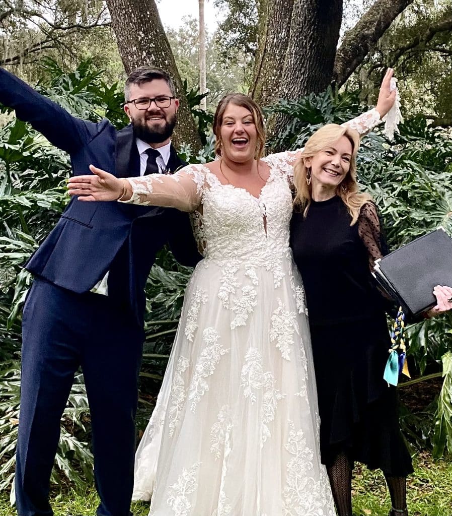 bride and groom celebrating in the forest with officiant from Freebird Ceremonies