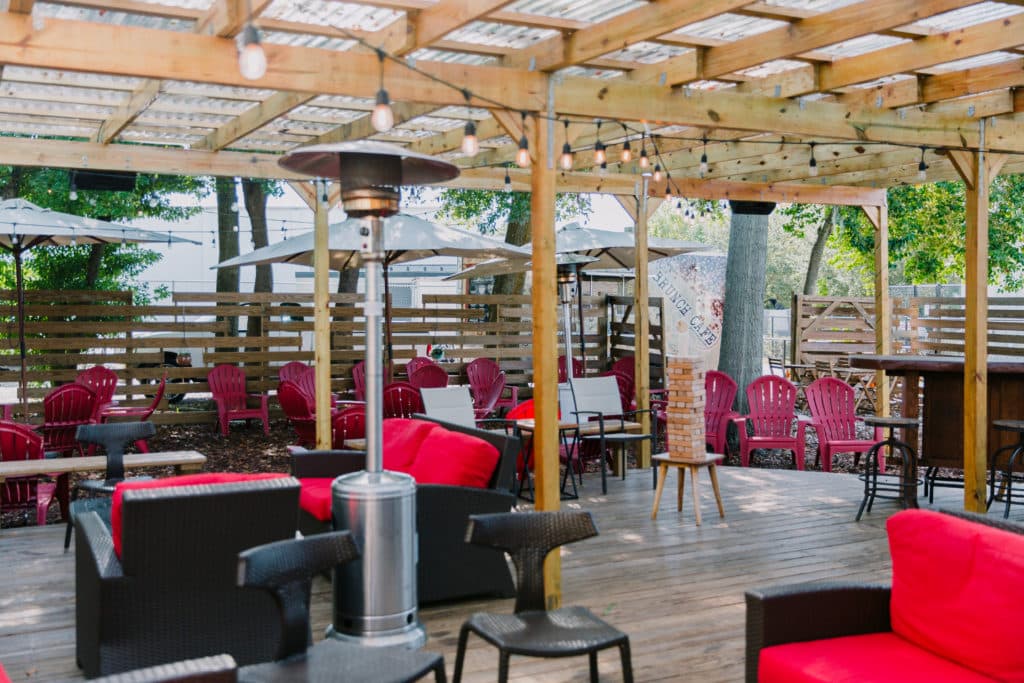 outdoor seating area with heaters at the Grape & The Grain Wine Bar