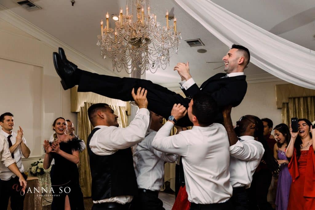 groom being tosses to music from Elegant Entertainment DJ and Video Services Orlando