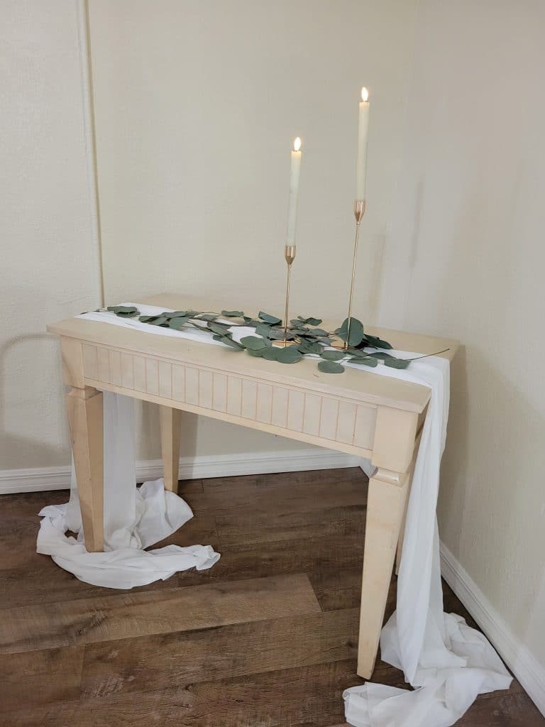 candle and tablecloth draped table at The Lake House at Tropical Resort & Marina