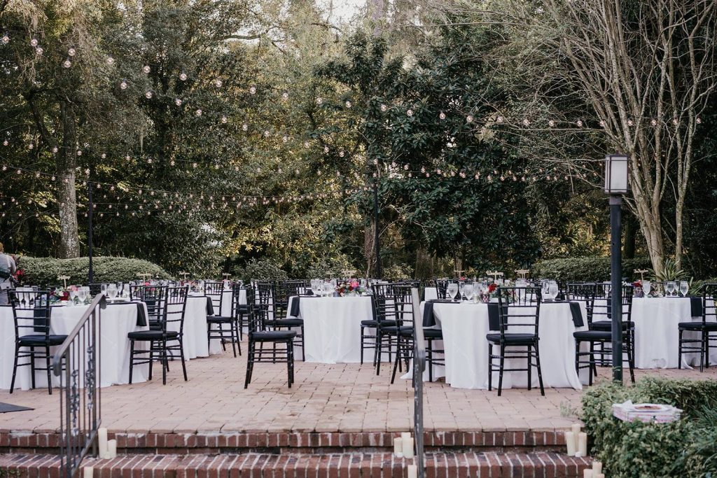 outdoor wedding reception with black and white under market lights at The Garden Villa
