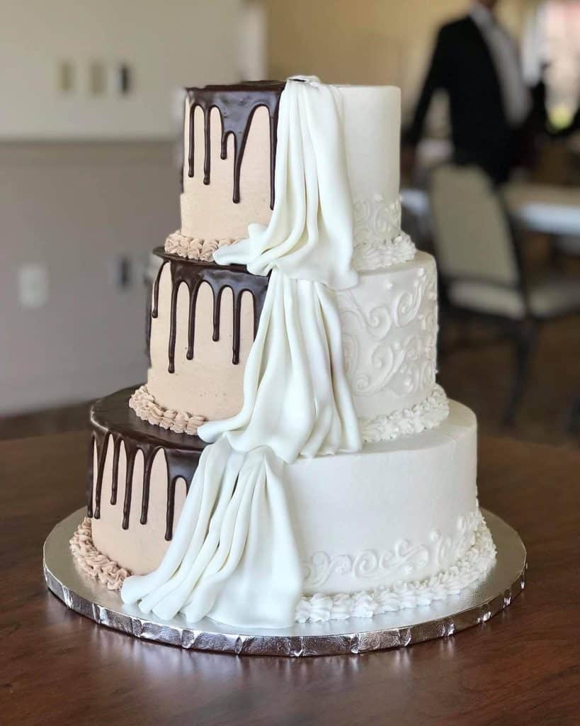 half bride and half groom three tiered wedding cake of chocolate and vanilla by Cake & Bake