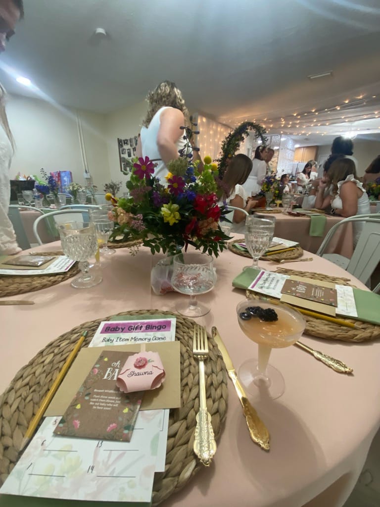 wedding reception rounds with gold accents and pink flowers at The Lake House at Tropical Resort & Marina