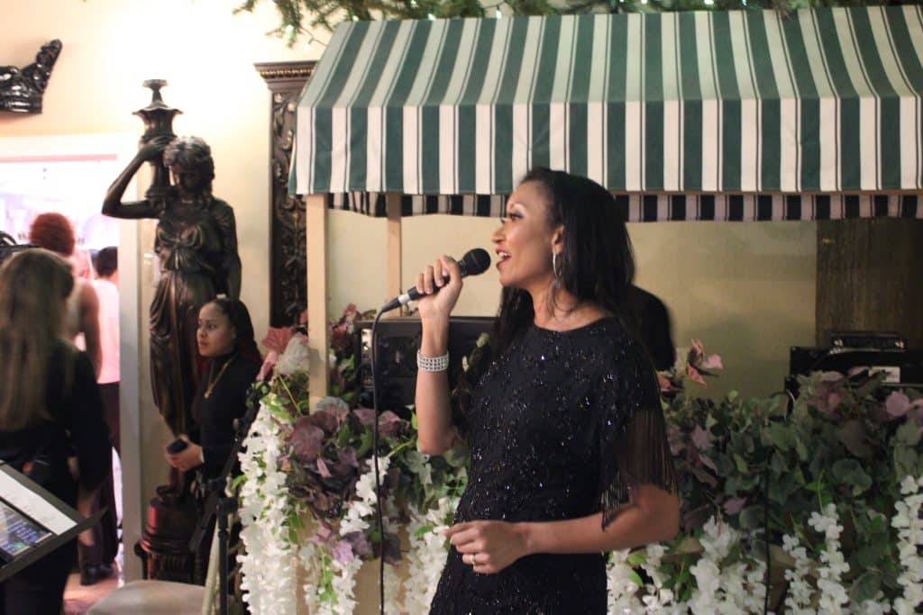 Deanna L. Giron - Singer & Pianist sings during a show