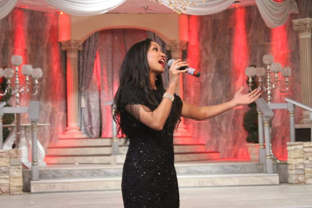 Deanna L. Giron - Singer & Pianist sings during a show