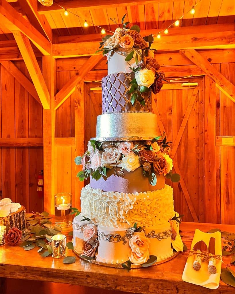tiered wedding cake with purple and lavender accents by Cake & Bake